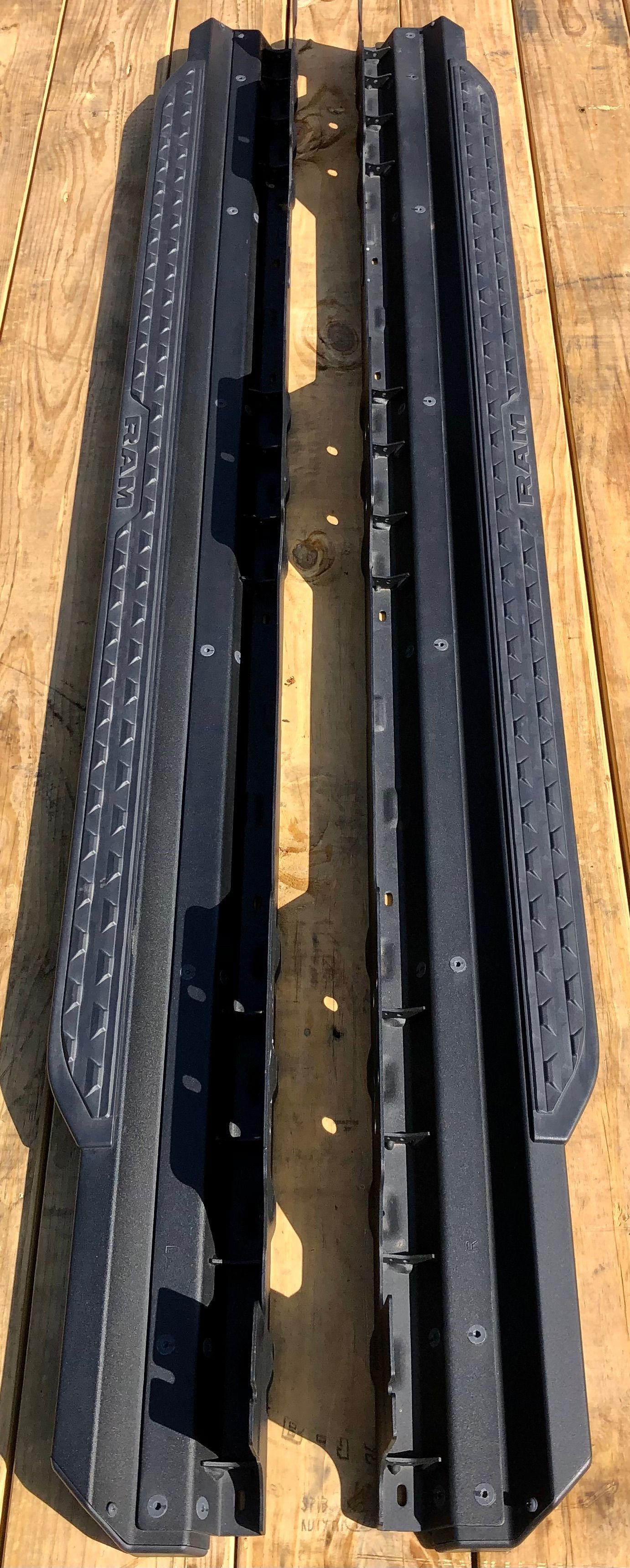 A pair of black side steps are sitting on top of a wooden table.