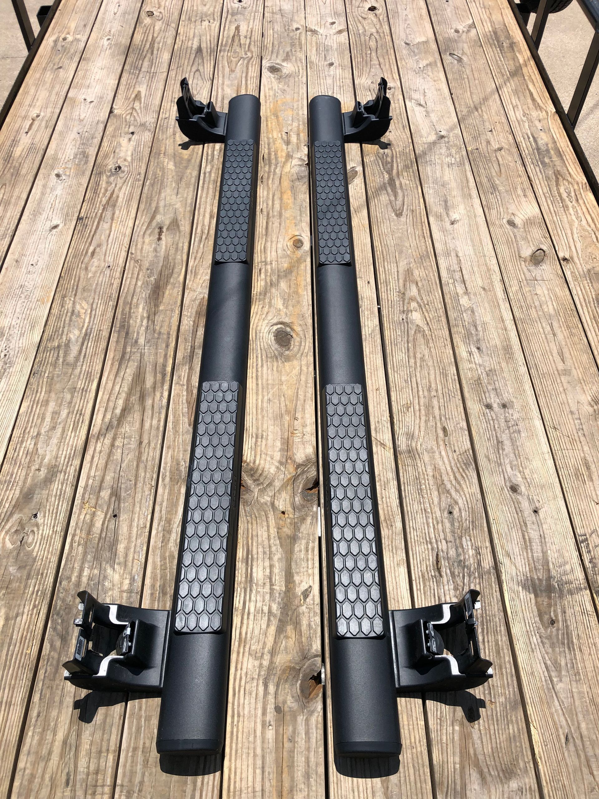 A pair of side steps are sitting on top of a wooden deck.