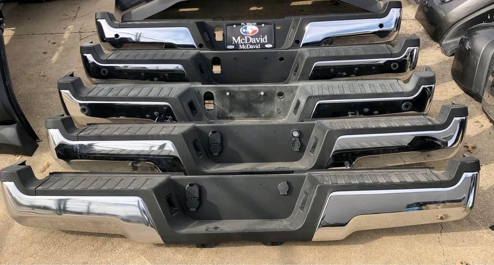 A bunch of bumpers are stacked on top of each other on the ground.