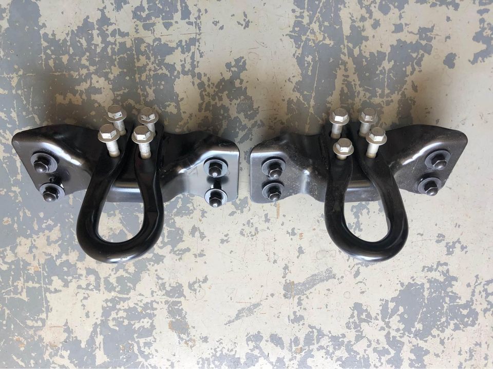 A pair of black hooks on a gray surface