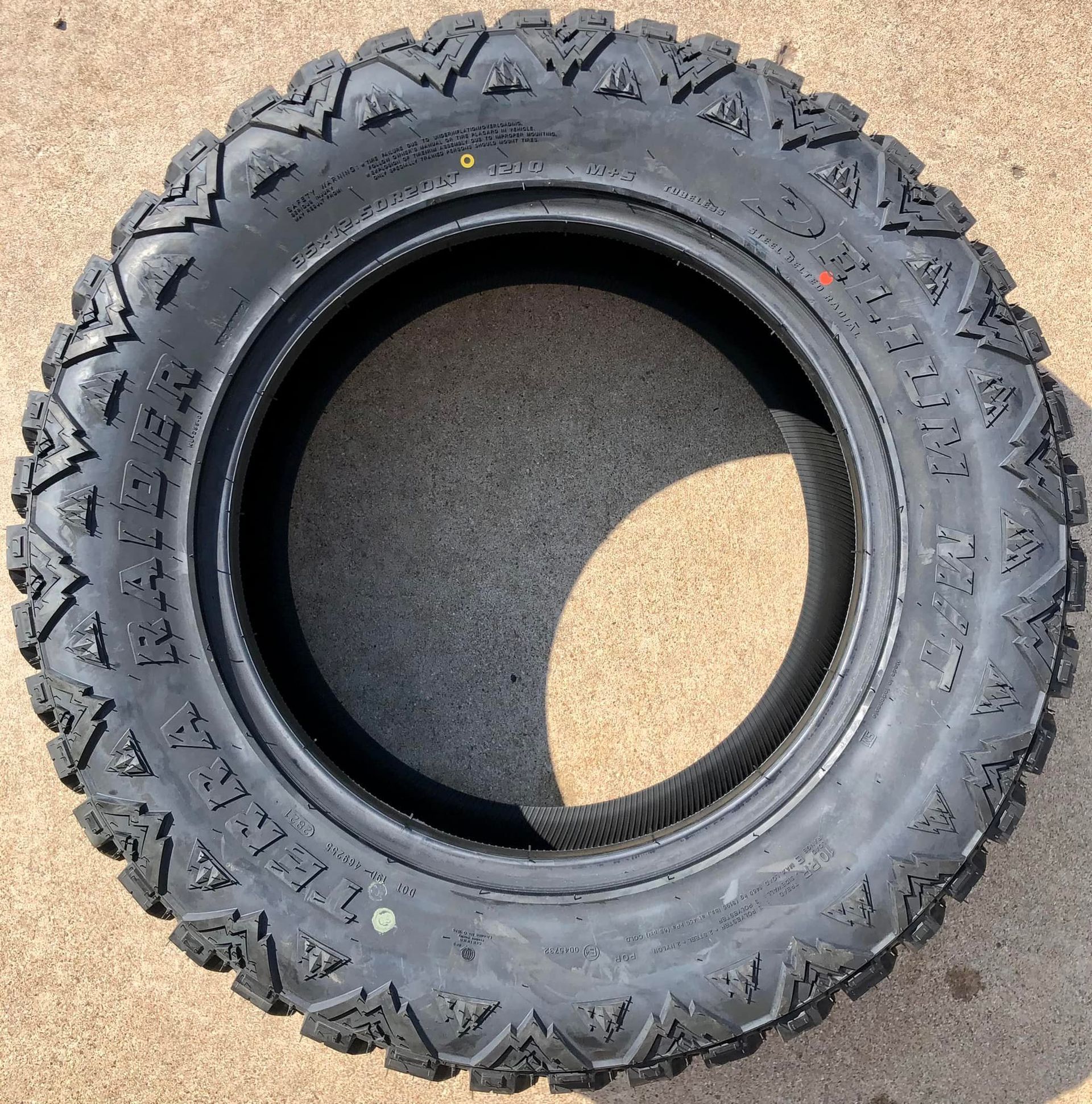 A tire that has the word terrain on it