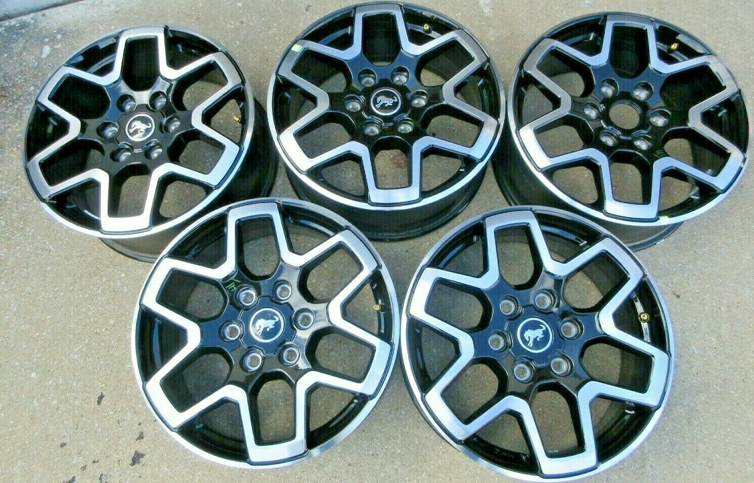 A set of black and silver wheels with a circle in the middle