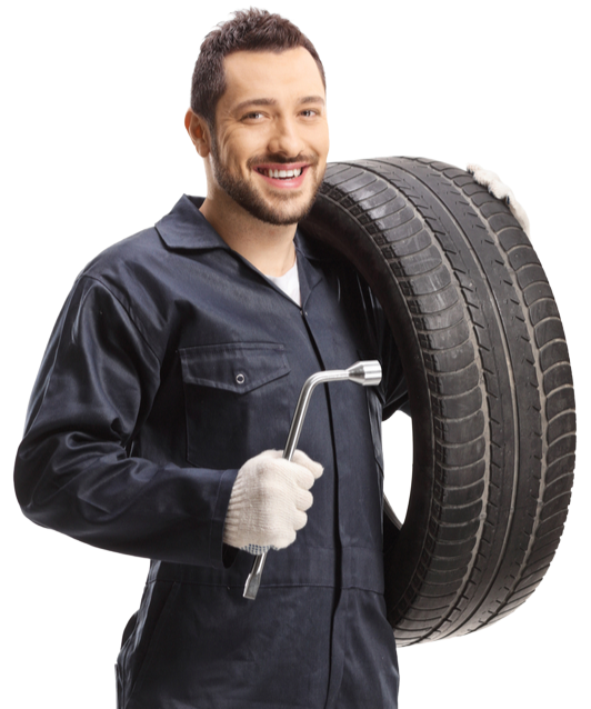 A man is holding a tire and a wrench.