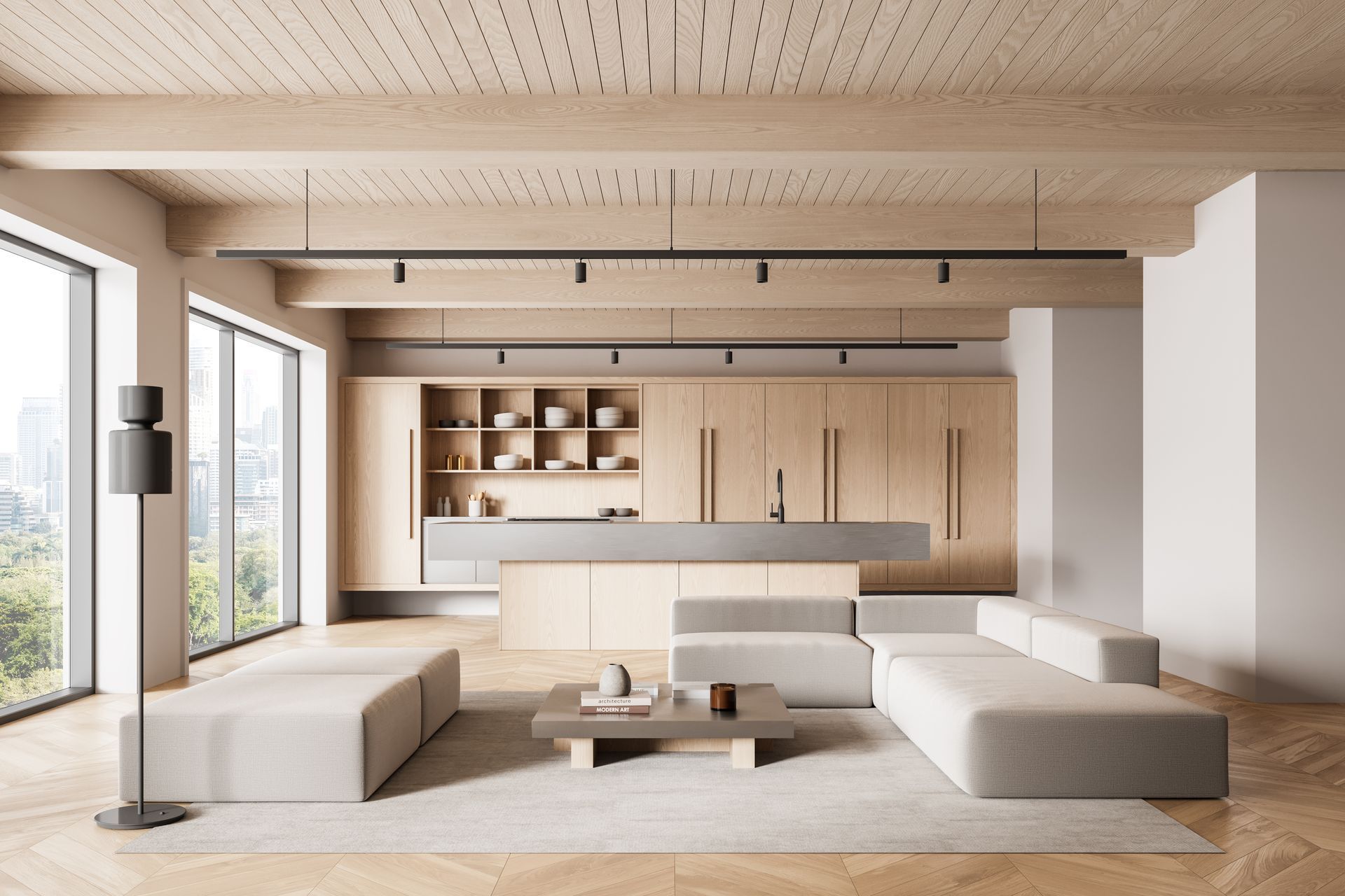 Modern open-plan living space with light wood cabinetry, large windows, and a sectional sofa.