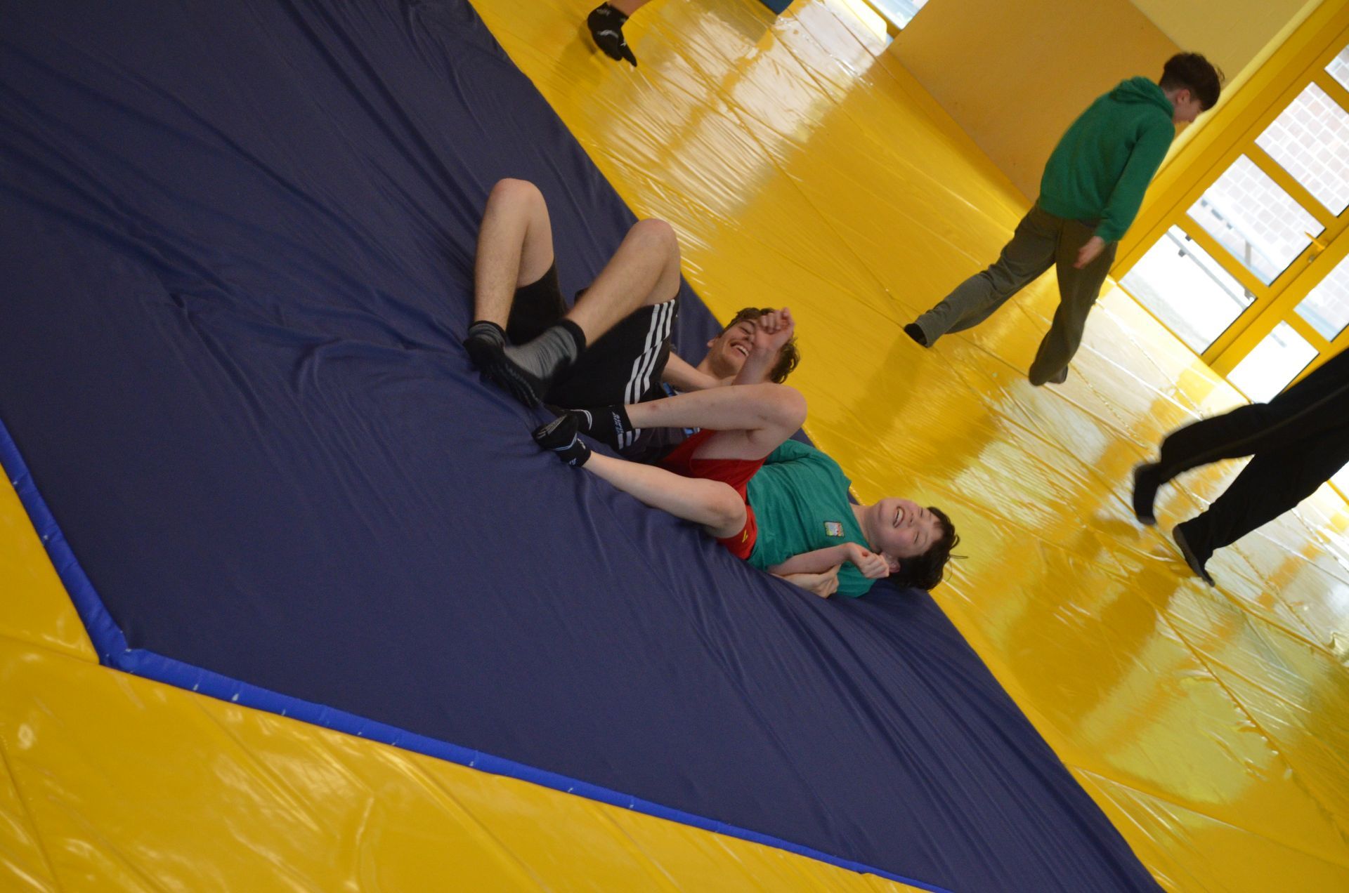 Zwei Männer ringen in einem Fitnessstudio auf einer Matte - Karate-Jugendfreizeit.