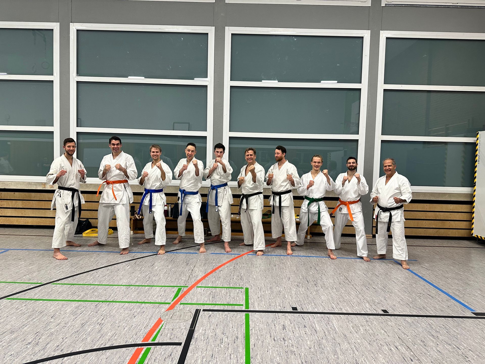 a group of men in karate uniforms are posing for a picture