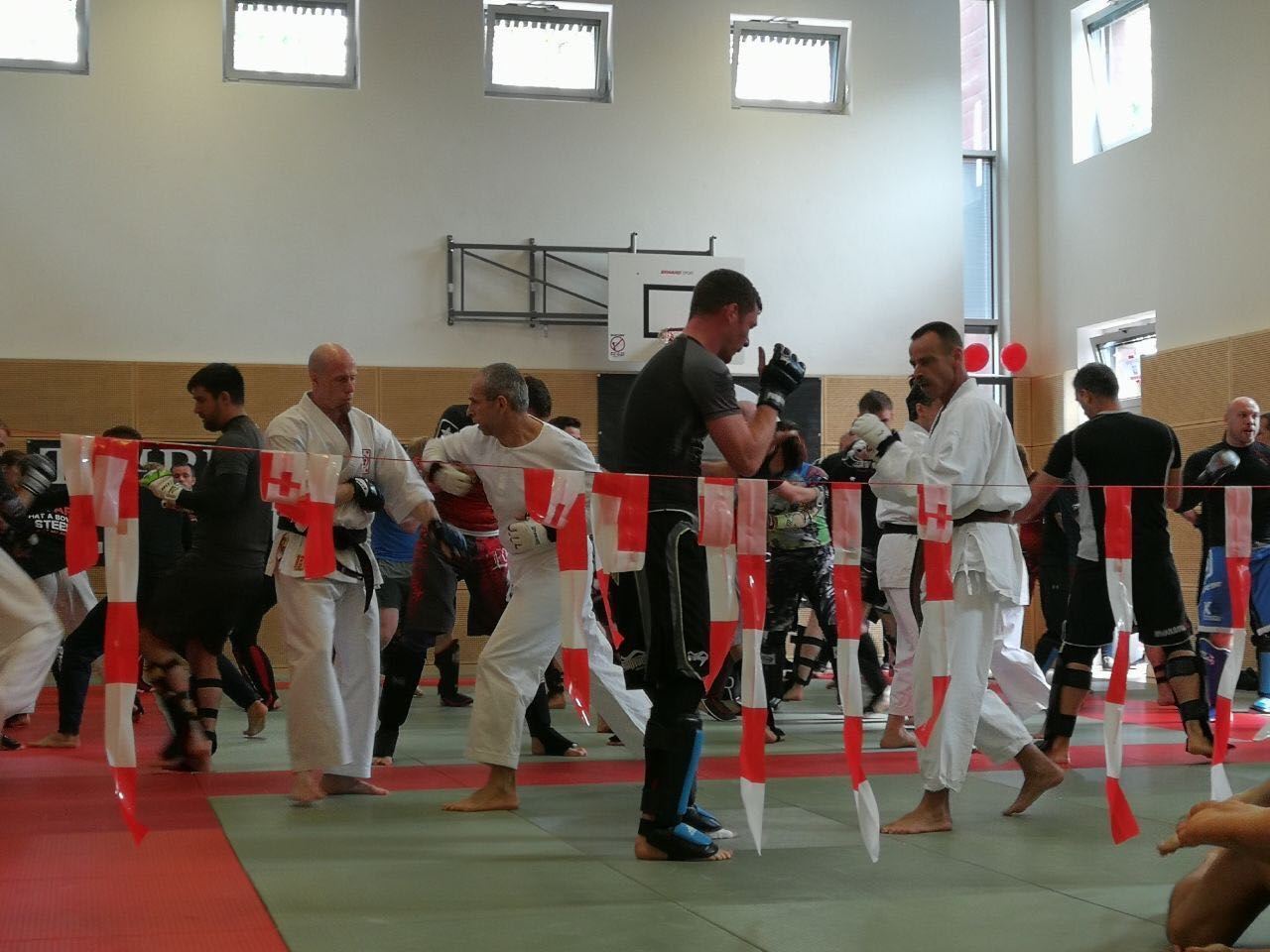 Eine Gruppe von Männern praktiziert Kampfsport in einem Fitnessstudio