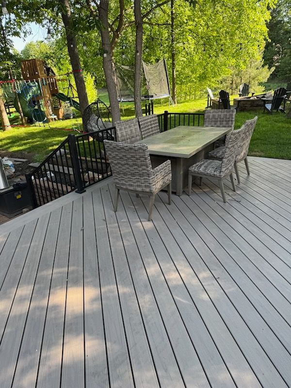 A wooden deck with a table and chairs on it