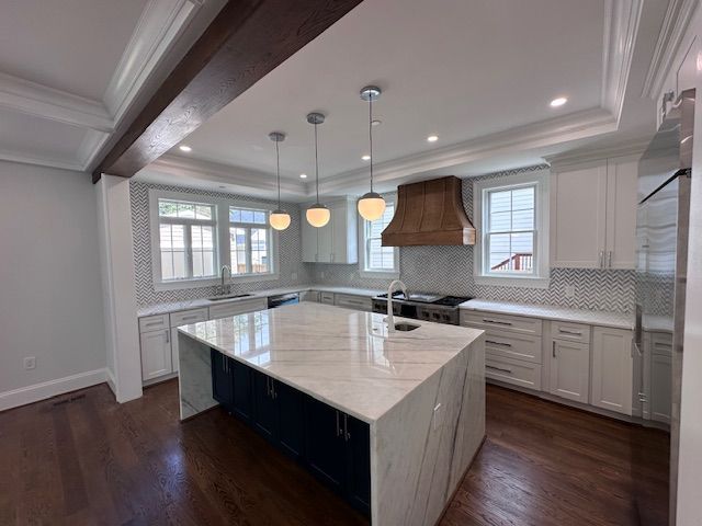 There is a large island in the middle of the kitchen.