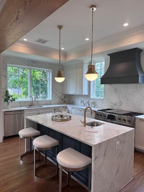 A kitchen with a large island and stools