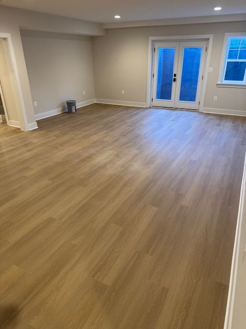 A room with a wooden floor and a sliding glass door