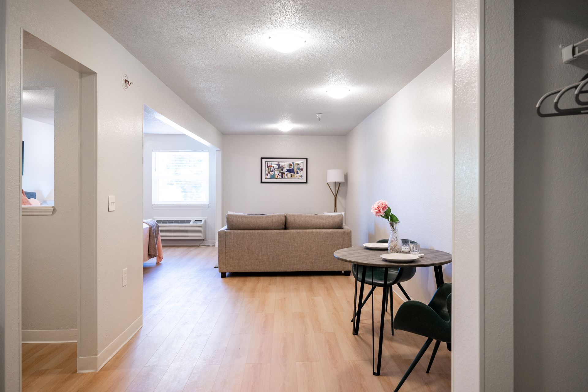 A living room with a couch , table and chairs