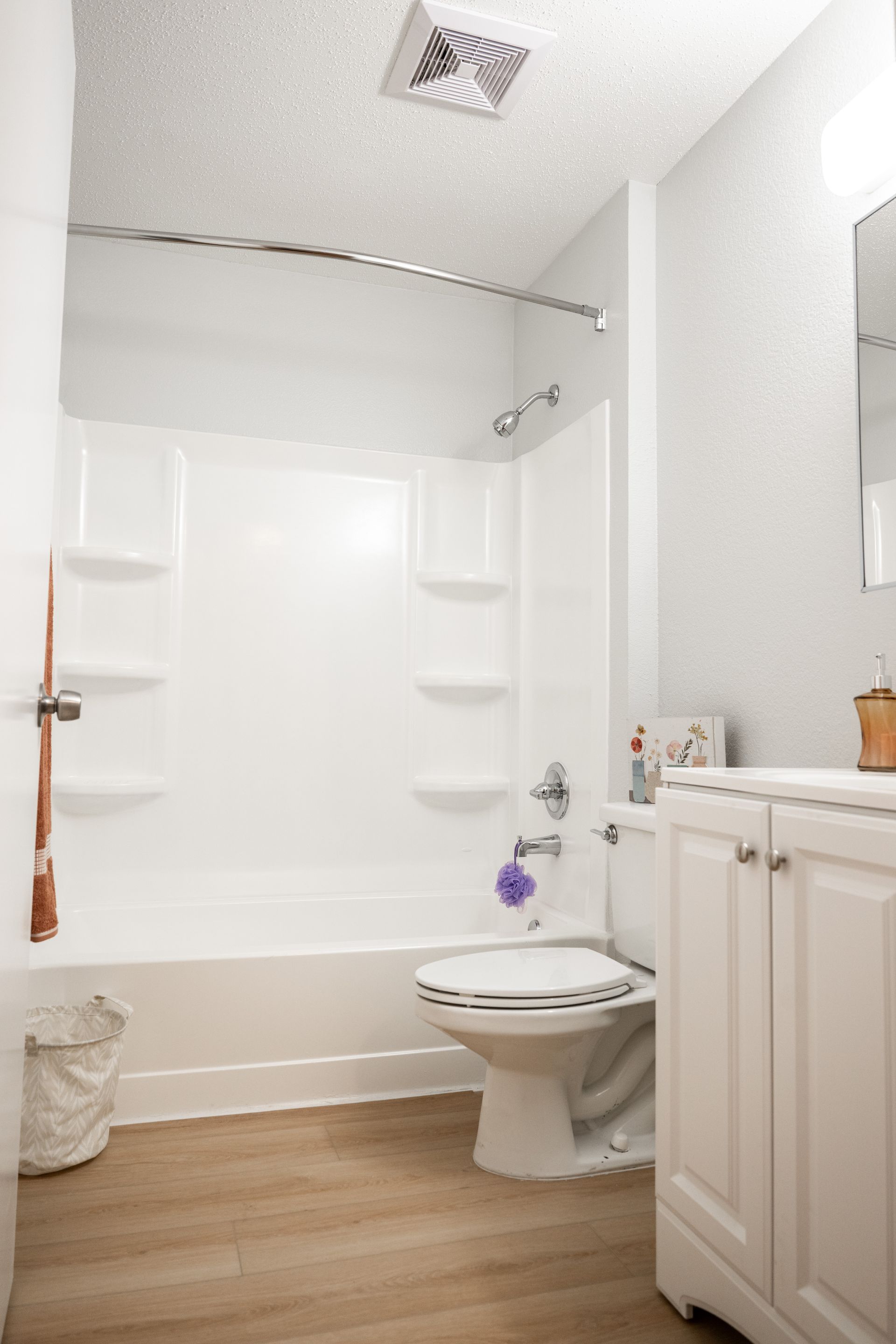 A bathroom with a toilet , sink , bathtub and shower.