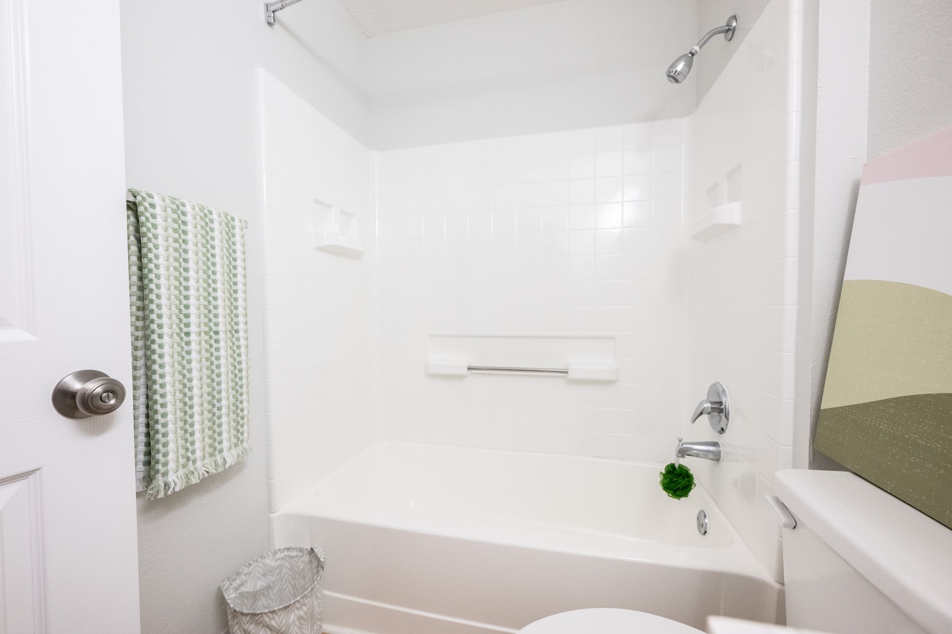 A bathroom with a tub , toilet and shower.