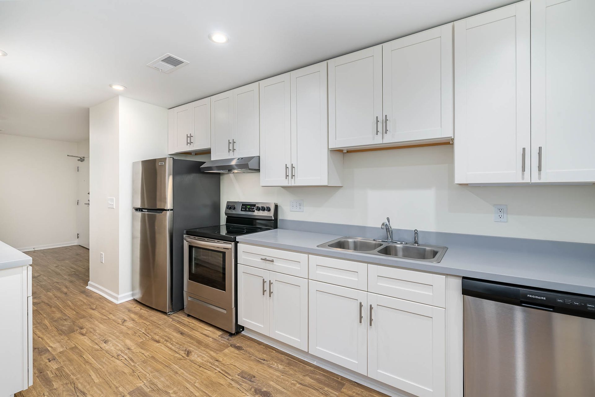 A kitchen with white cabinets and stainless steel appliances.