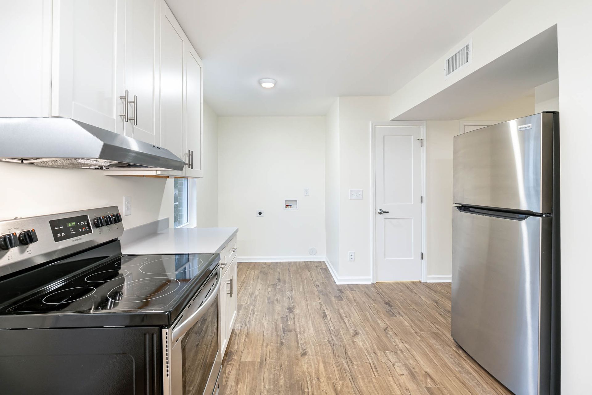 A kitchen with a stove , refrigerator , and stainless steel appliances.