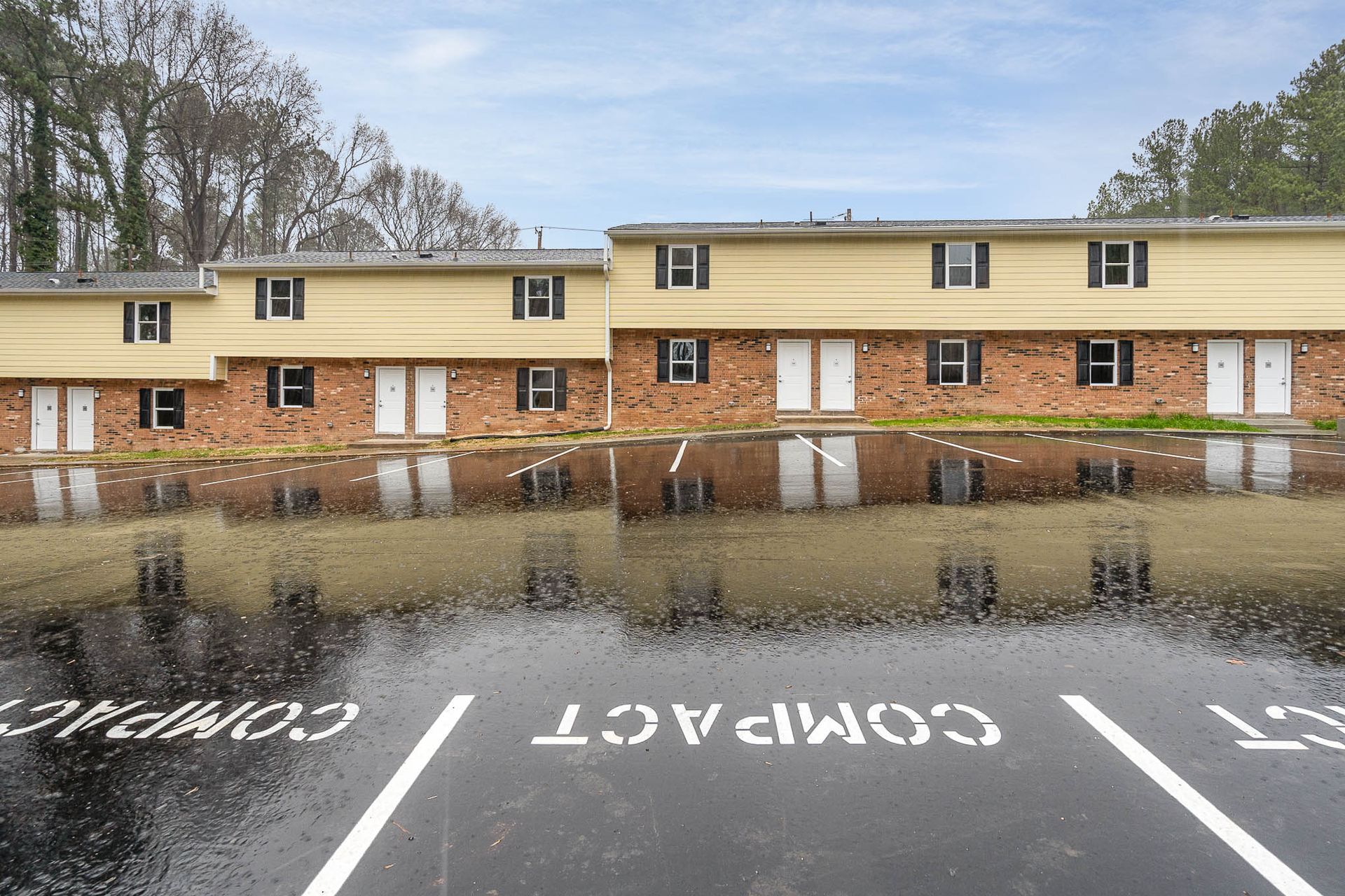 A parking lot with compact written on it