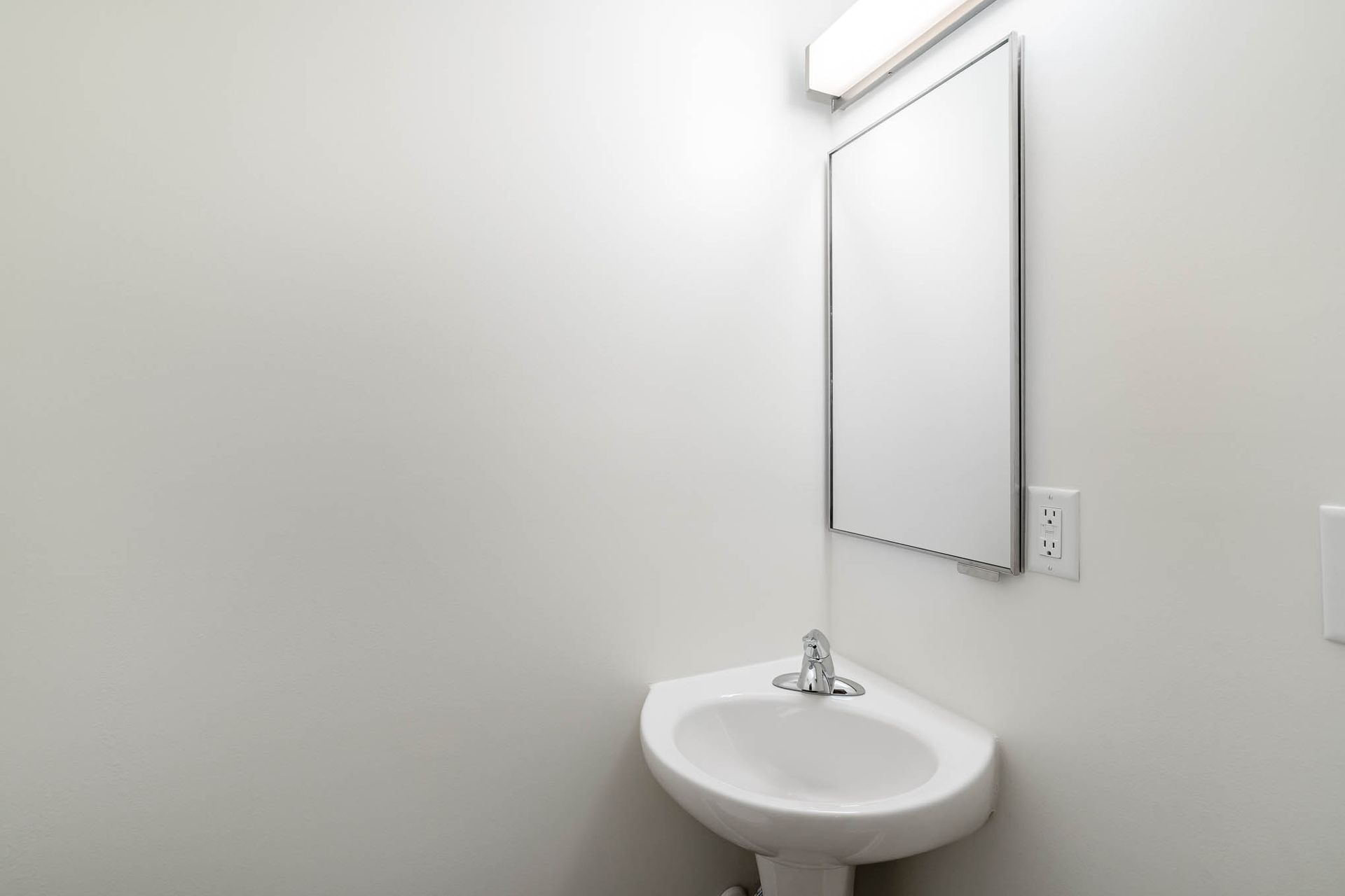 A bathroom with a sink and a mirror on the wall.