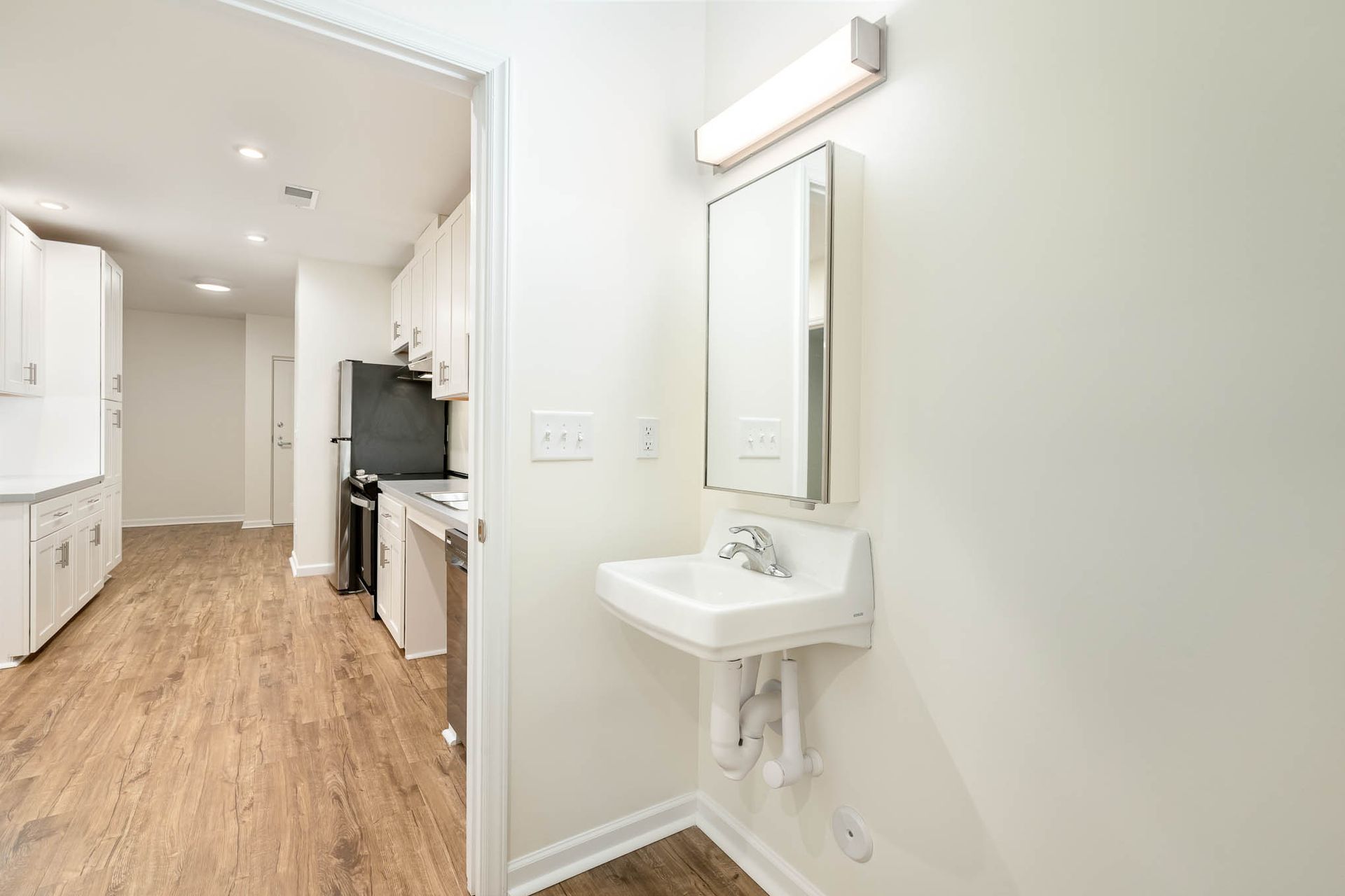 A bathroom with a sink and a mirror.