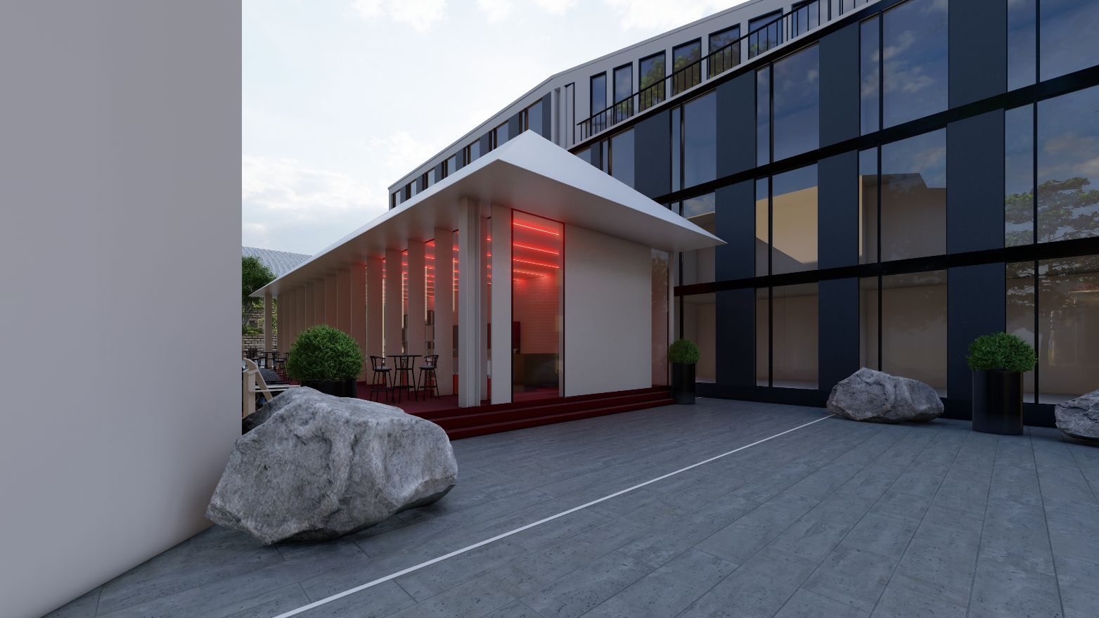 Ein großes Gebäude mit vielen Fenstern und einem großen Felsen davor.