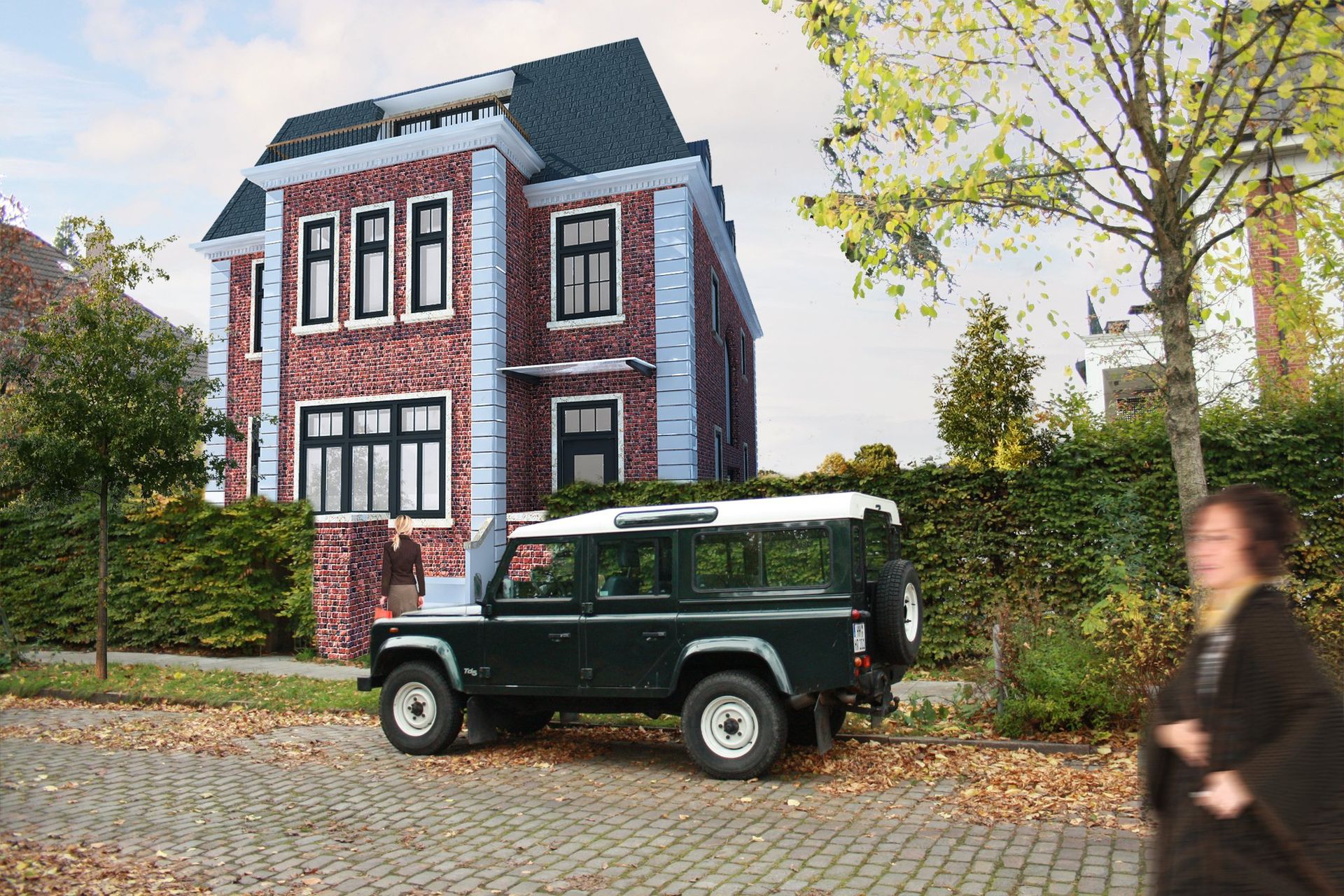 Ein grüner Land Rover steht vor einem großen Backsteinhaus