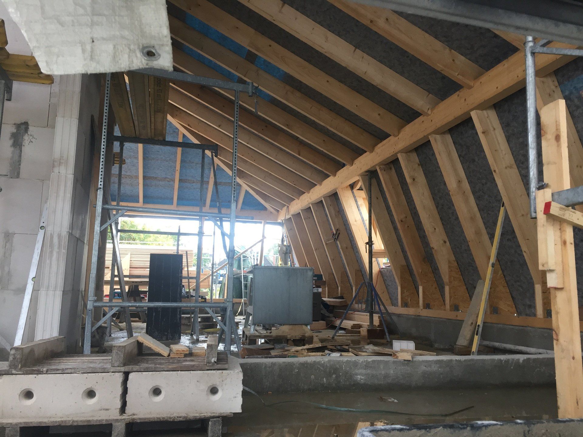 Ein im Bau befindliches Gebäude mit Holzbalken und Gerüsten