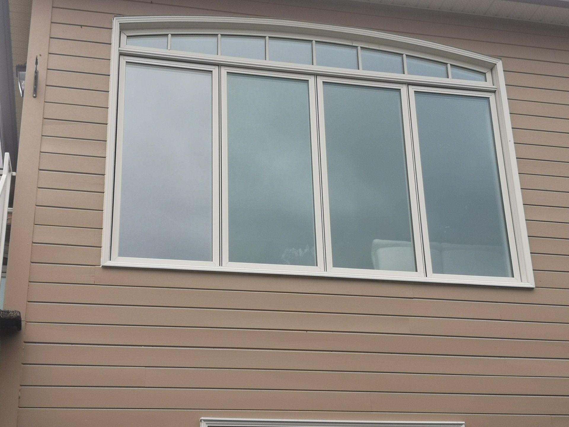 Une grande fenêtre sur le côté d'une maison