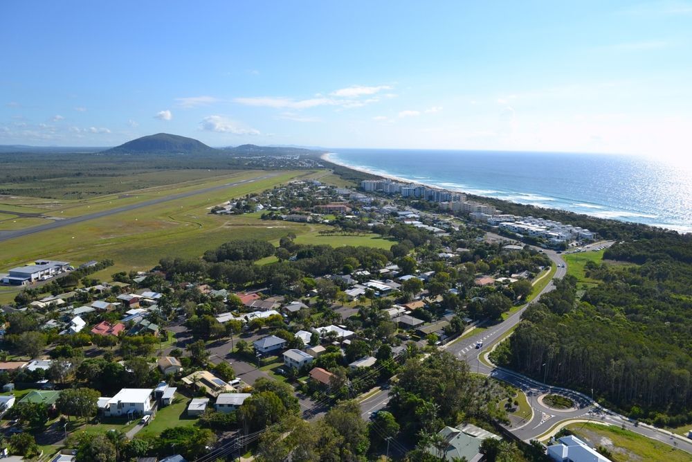 Aerial View of a Coastal Town With a Beach and Ocean on One Side — Brian Williams Electrical Air Solar in Coolum, QLD