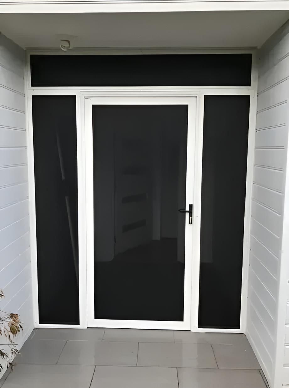 A White Door With Black Screens is Sitting on a Tiled Floor — Clearshield Security Screens in Shellharbour, NSW