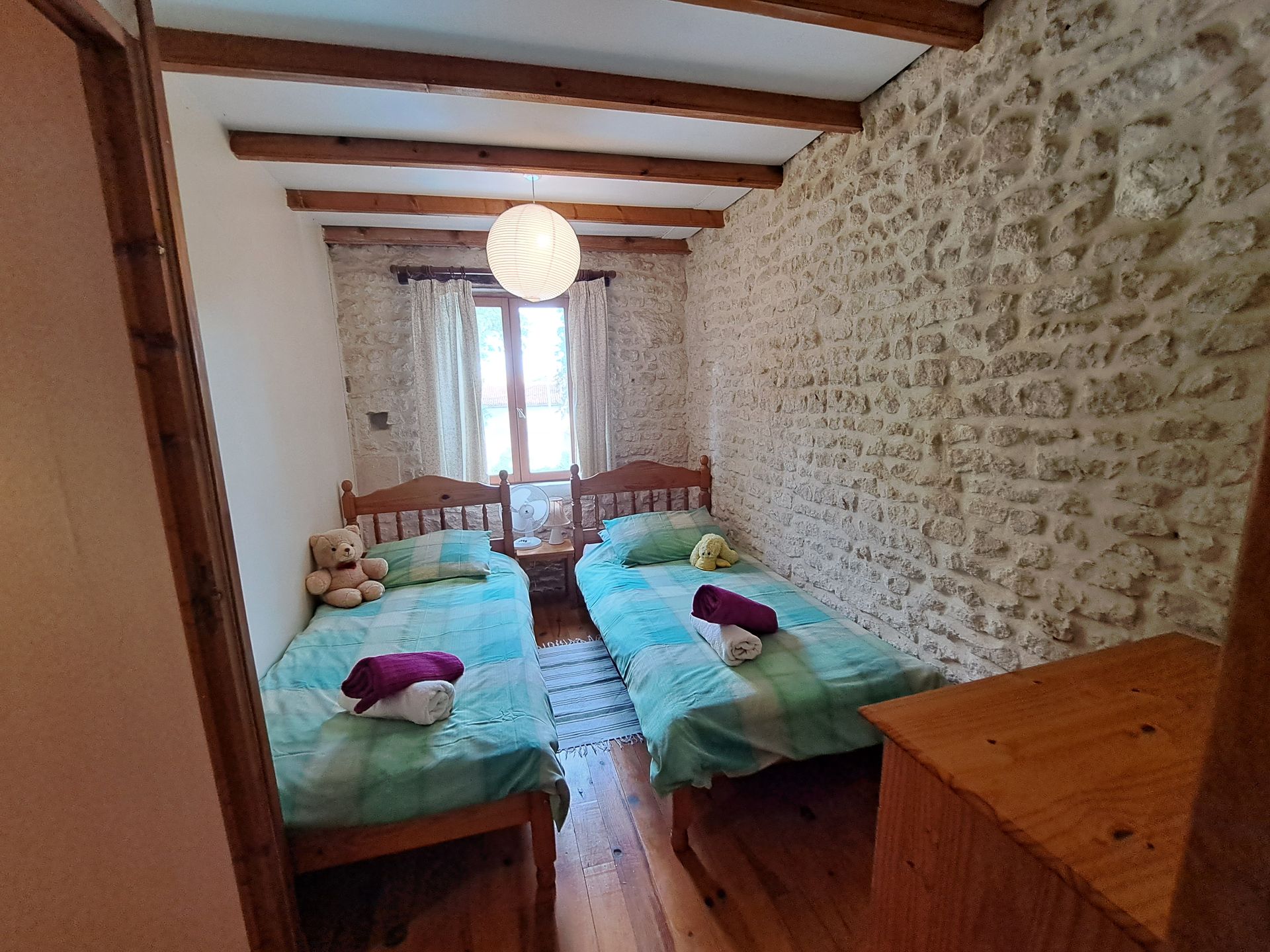 twin room with pine beds with dark green bedlinen