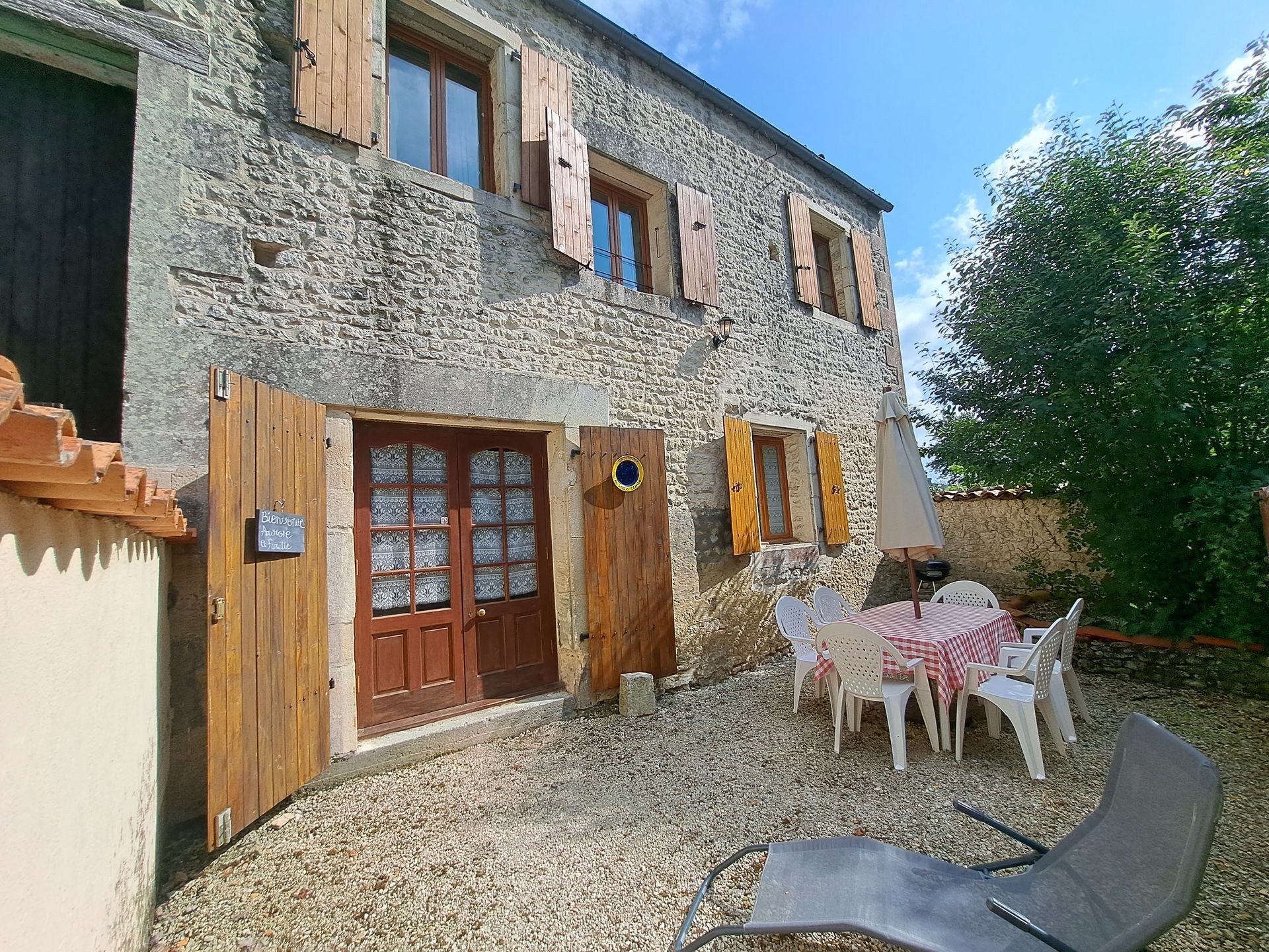 stone holiday cottage in France with wooden shutters