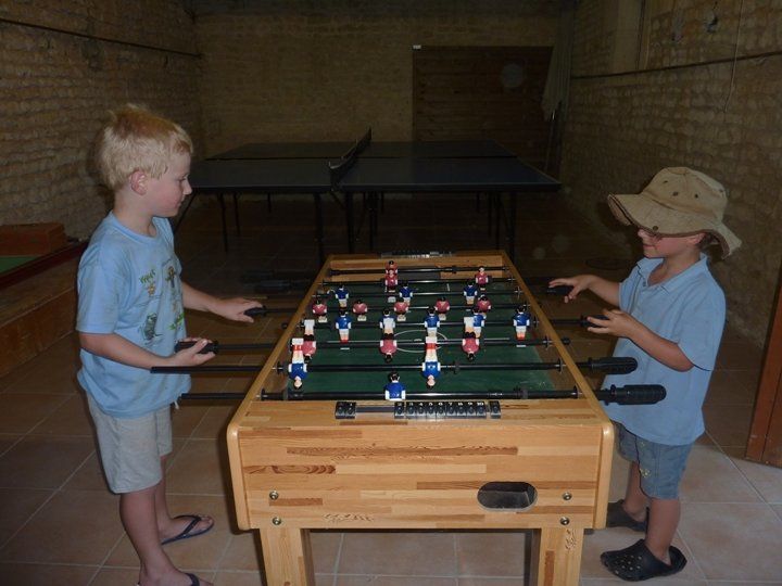 Two boys playing table football