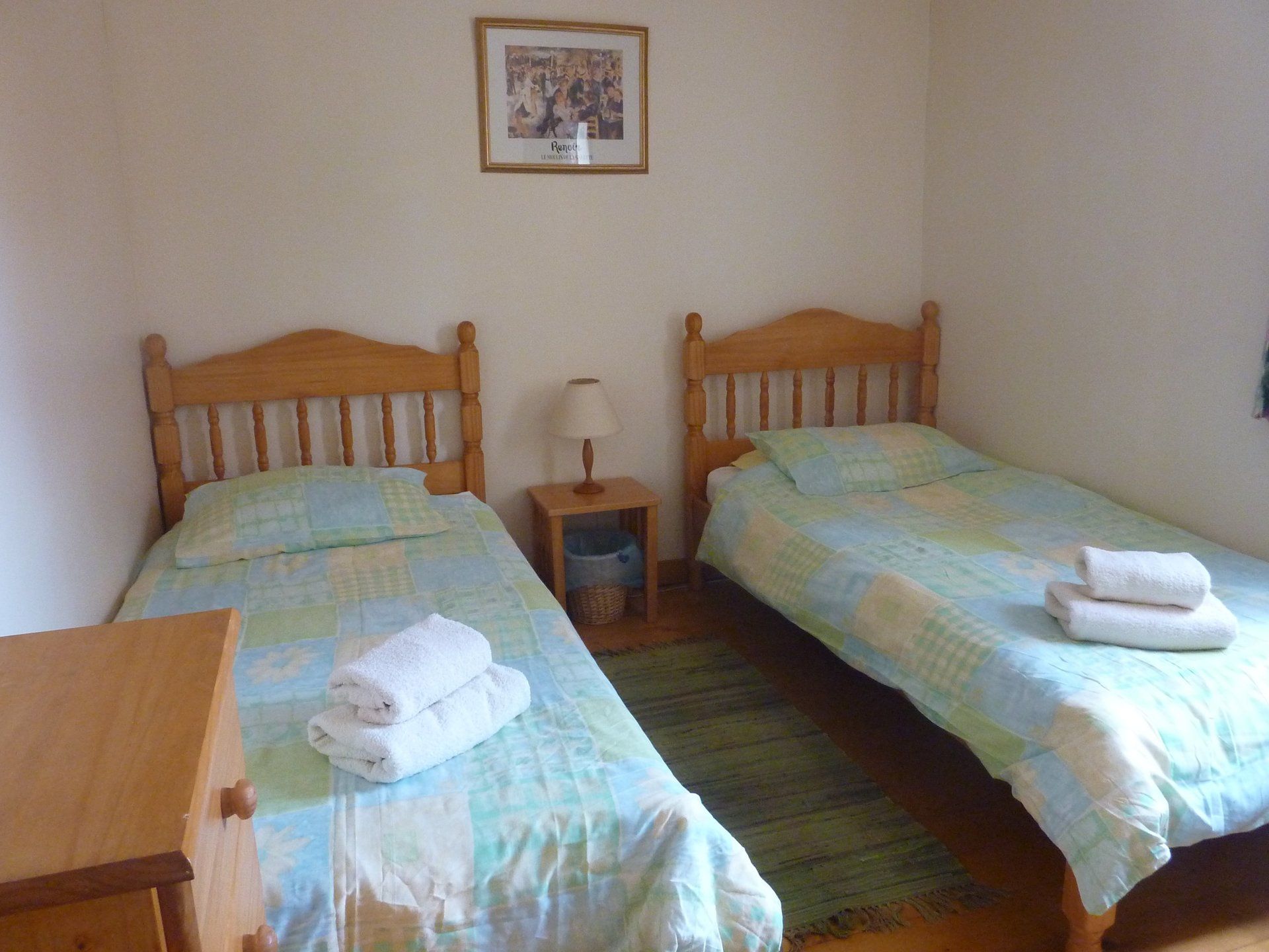 twin room with two single beds and green bedding