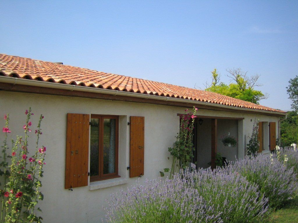 outside view of white villa with lavender