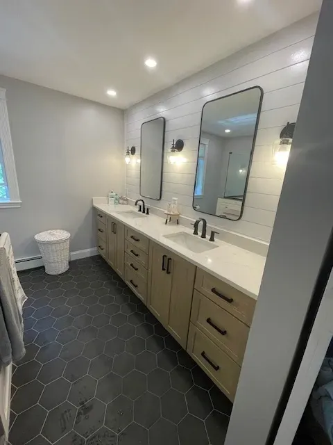 A bathroom with two sinks and two mirrors.