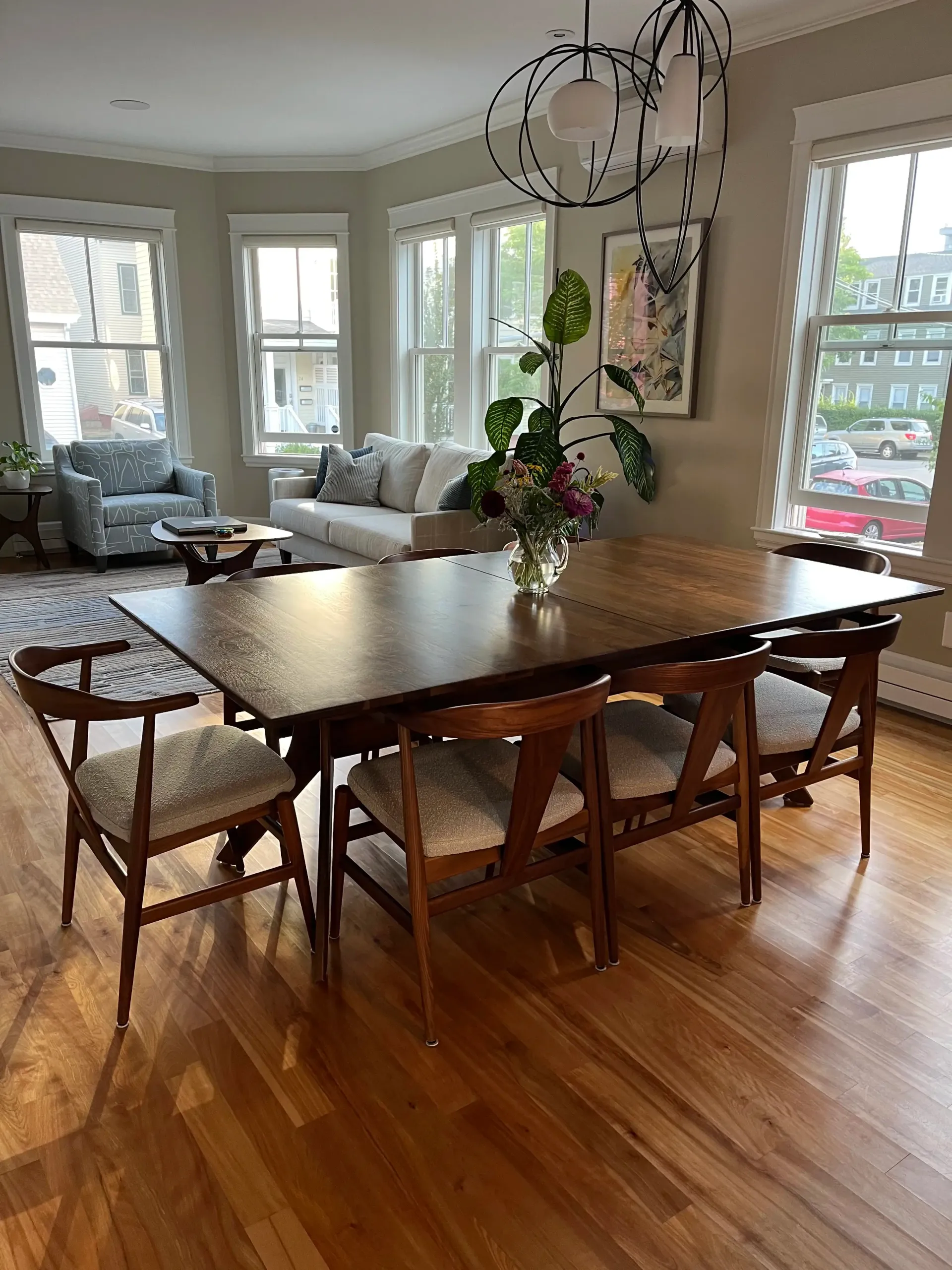 A living room with a couch , chair , table and television.