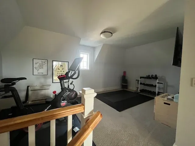 A room with a treadmill and a bike in it