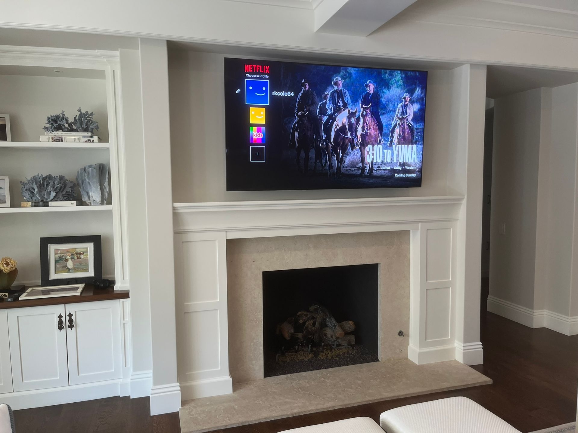 A living room with a fireplace and a flat screen tv