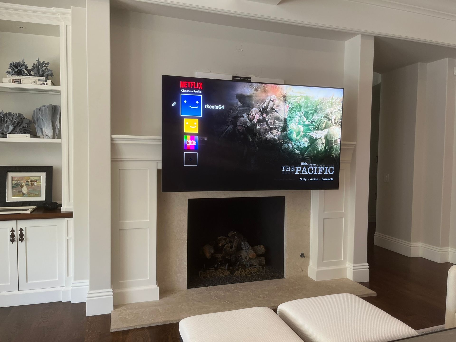 A living room with a fireplace and a flat screen tv