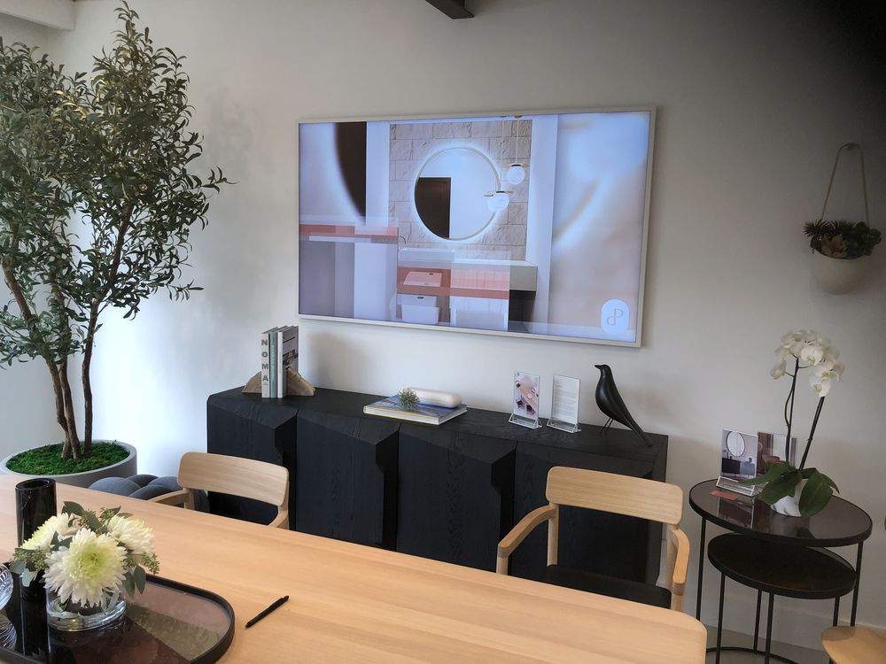 A dining room with a large flat screen tv on the wall