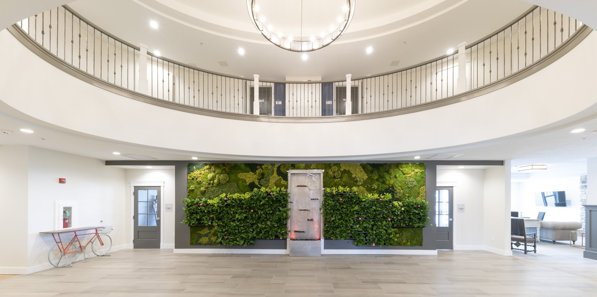 Large open interior space with a living wall and balcony. Bright with a modern design.