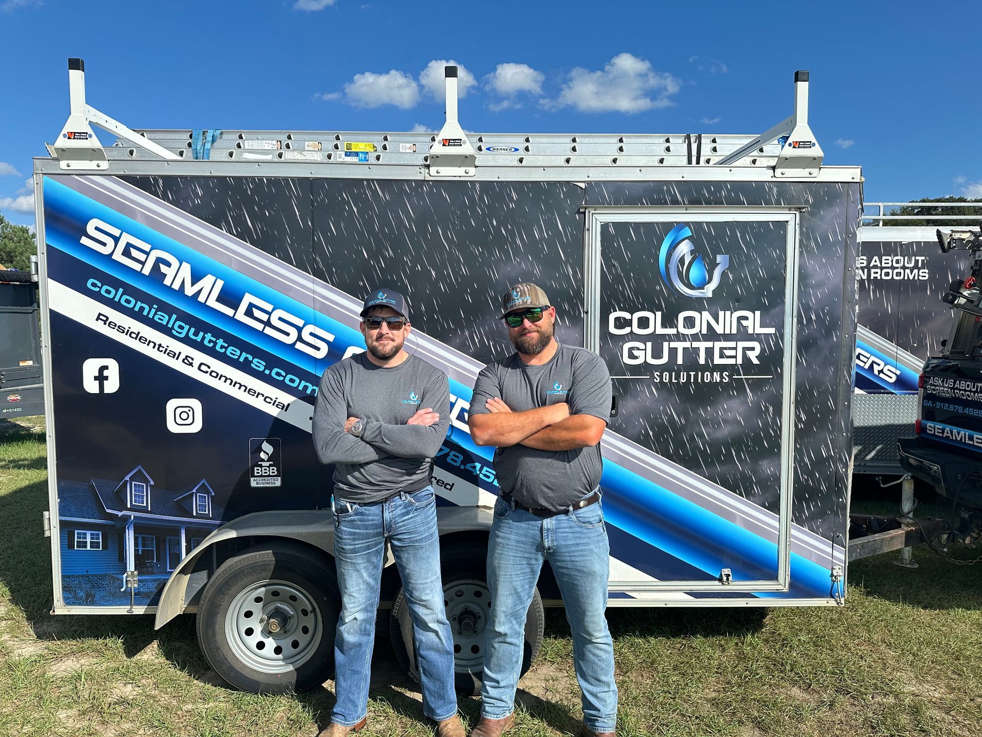 Two men are standing in front of a colonial gutter van.