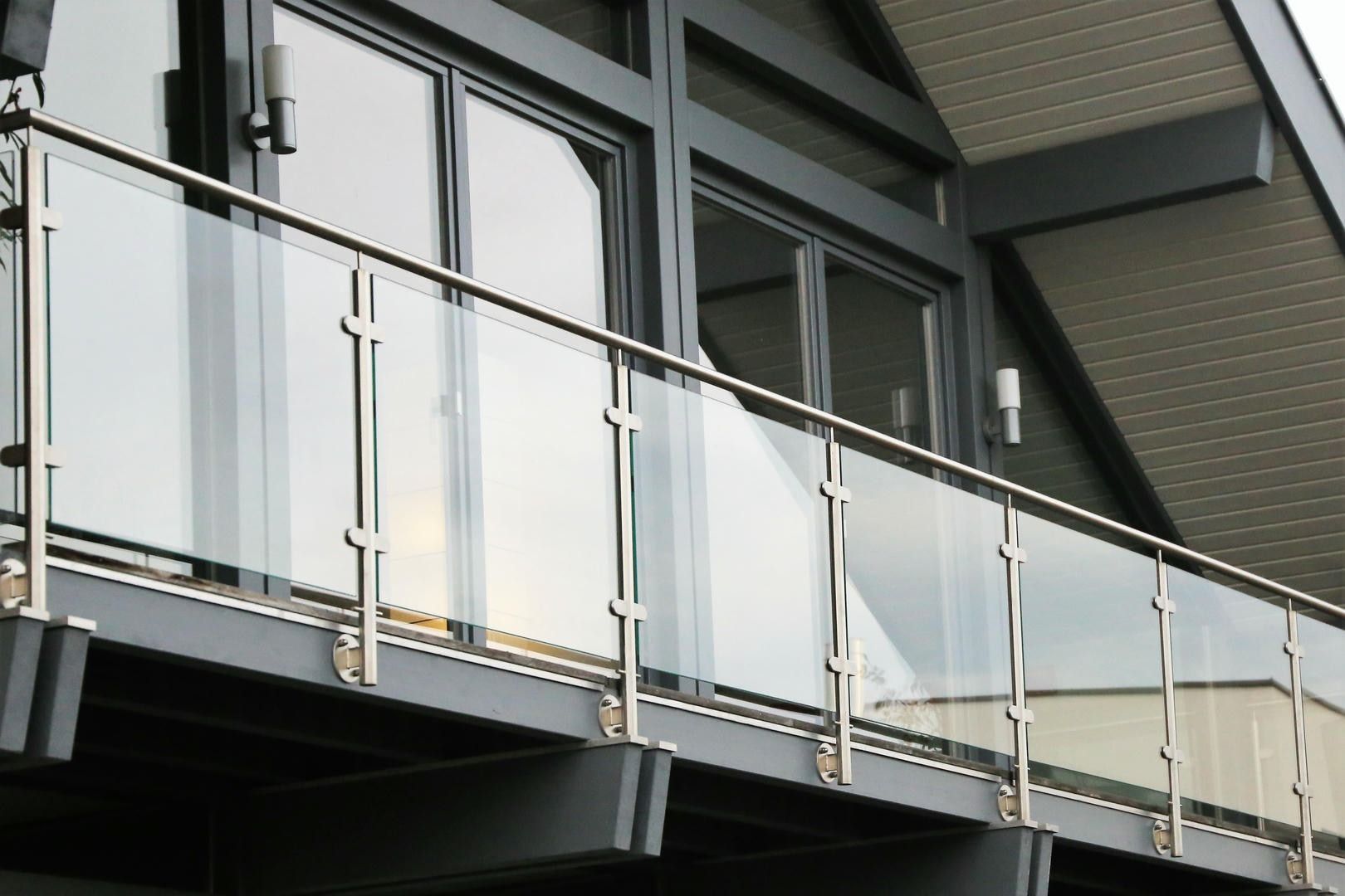 A balcony with a stainless steel railing and glass panels