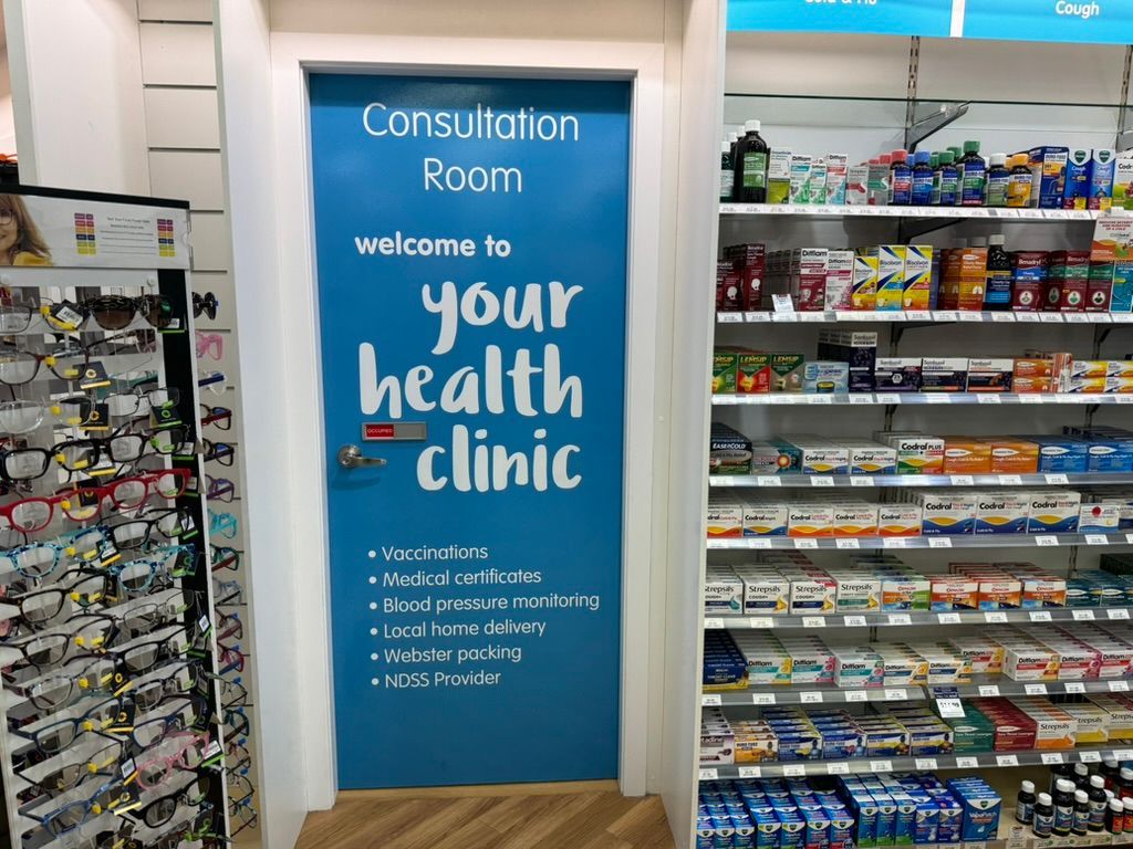 a Doctor is Holding Two Syringes in Her Hands — Warners Bay Pharmacy In Warners Bay, NSW