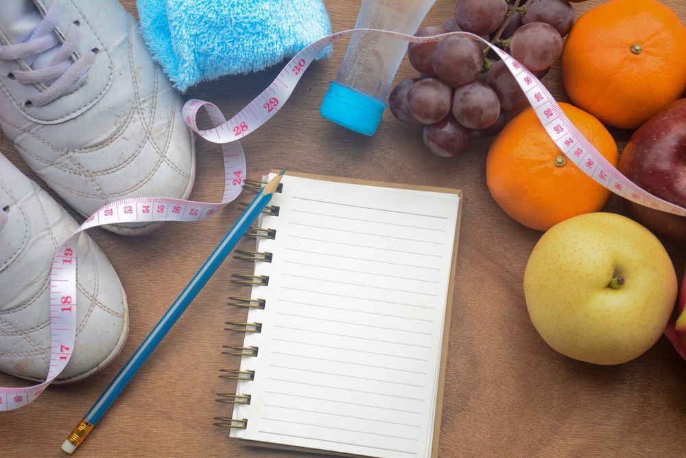 a Notebook , Pencil , Measuring Tape , Shoes , Fruit and a Water Bottle on a Table — Warners Bay Pharmacy In Warners Bay, NSW