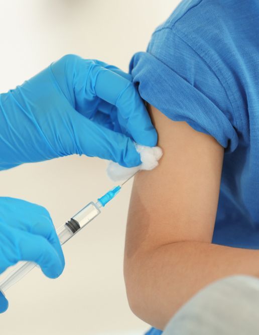 a Woman is Getting an Injection in Her Arm — Warners Bay Pharmacy In Warners Bay, NSW