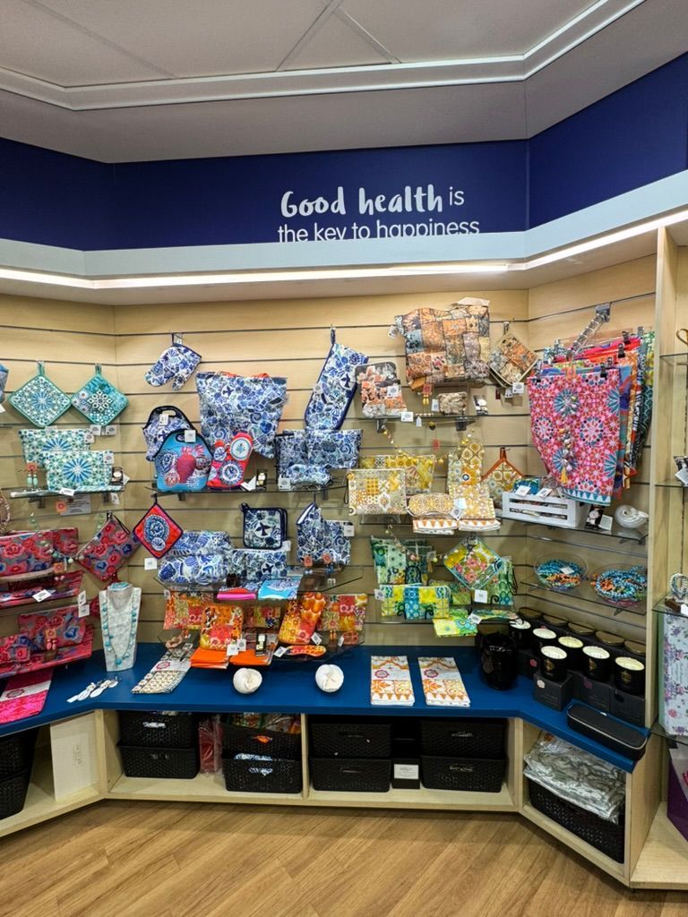a Display of Handbags Hanging on a Wall in a Store — Warners Bay Pharmacy In Warners Bay, NSW