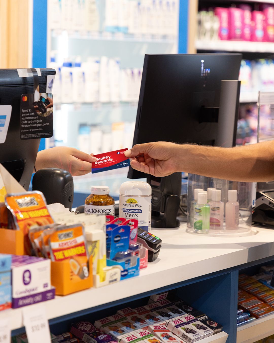 A Pharmacist is Looking at a Prescription in a Pharmacy — Warners Bay Pharmacy In Warners Bay, NSW