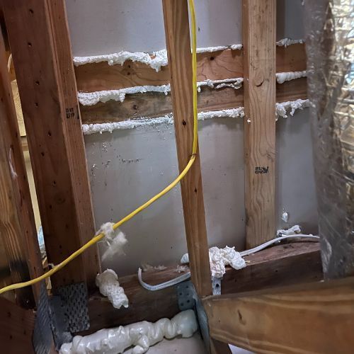 A wooden frame with foam and wires coming out of it.