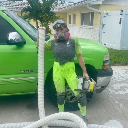 A woman wearing a gas mask is standing next to a green truck